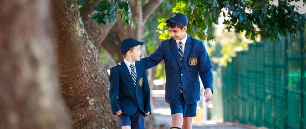 Well-dressed schoolboys in navy blazers and ties walking together outdoors, showcasing school uniforms, school ratings, and student collaboration in South Africa.