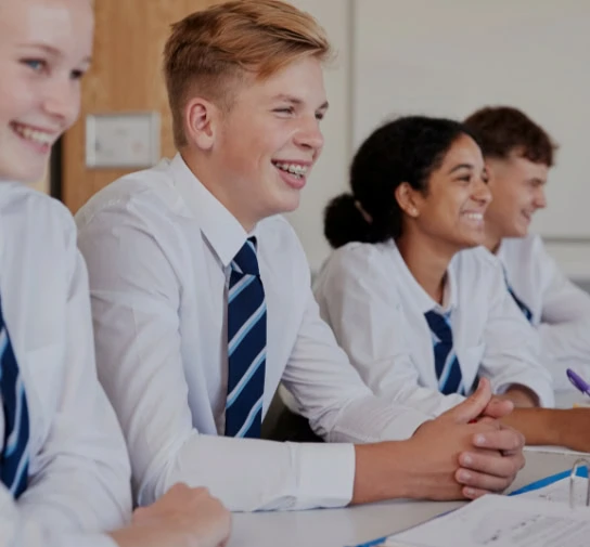 High school students laughing with teacher
